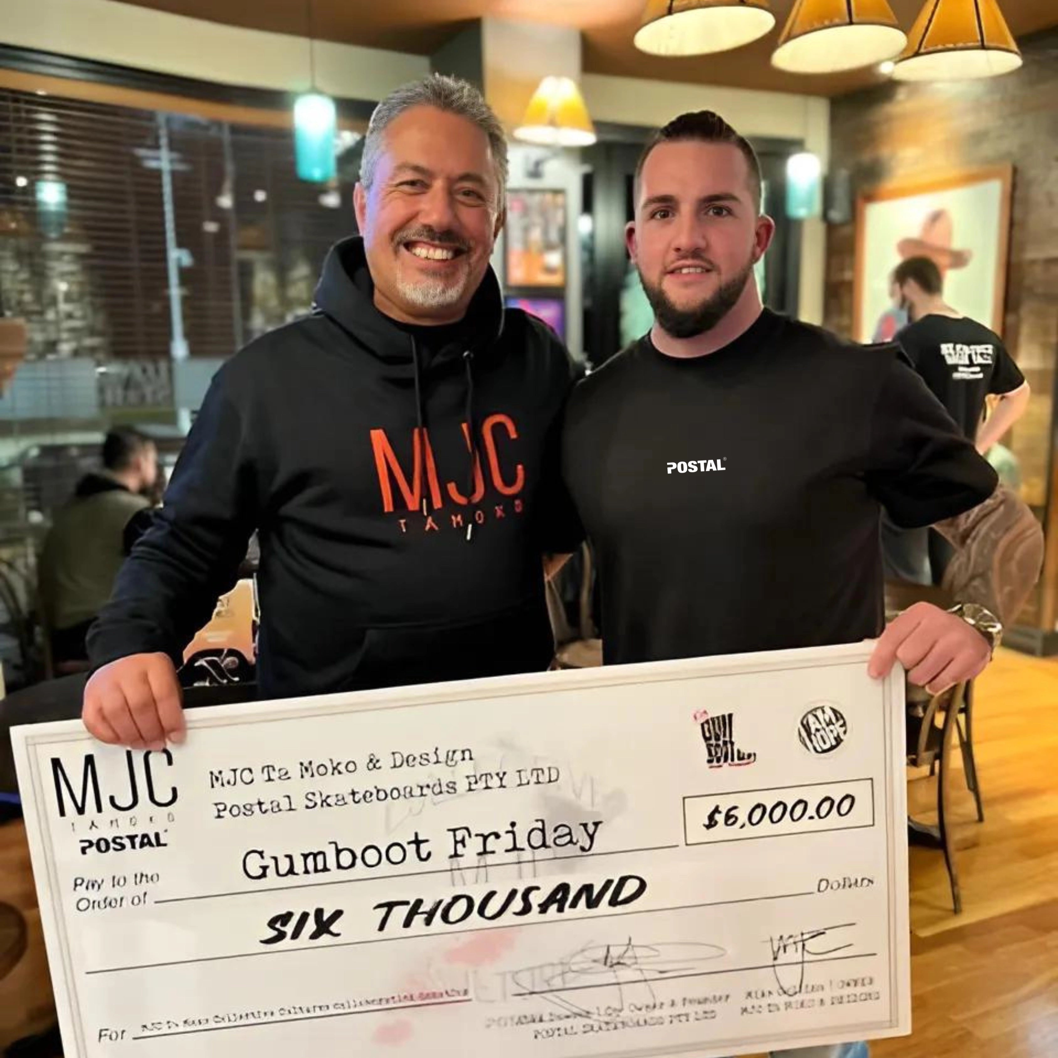 Michael Collins of MJC Ta Mōko presenting a $6,000 donation cheque to Mike King for Gumboot Friday and I AM Hope charities, supporting youth mental health.
