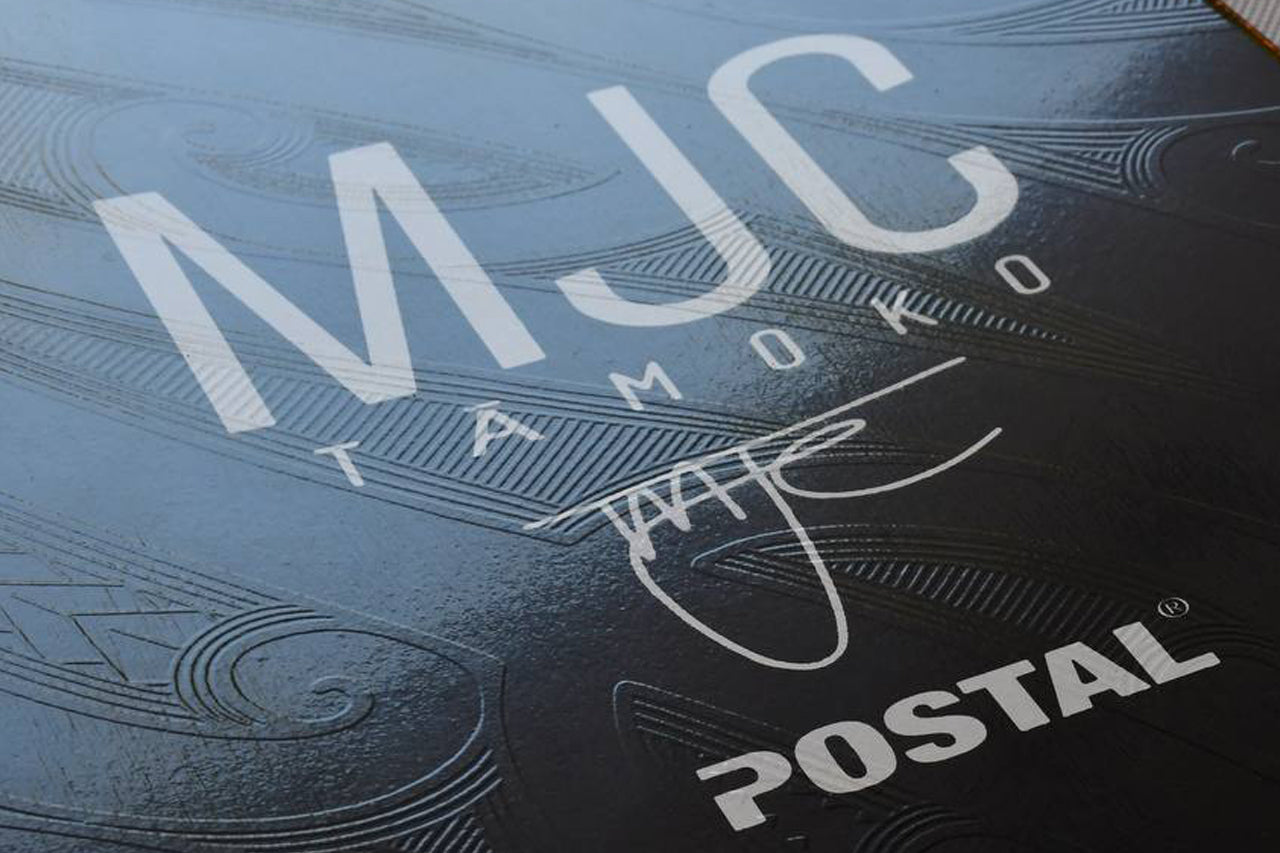Close up of top of deck embossed design of Maori Māna Skateboard Deck MJC tā moko and Postal Skateboards collective collaboration 